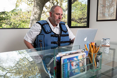 Man at desk wearing AffloVest