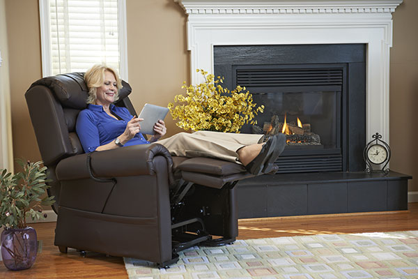 woman laying and reading in a recliner